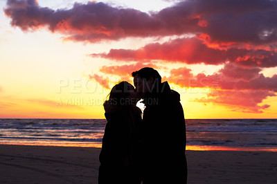Buy stock photo Beach, sunset and couple silhouette kiss in nature with love, freedom and romance outdoors. Shadow, romantic and people kissing at sunrise, sweet and together for travel, vacation or holiday in Bali