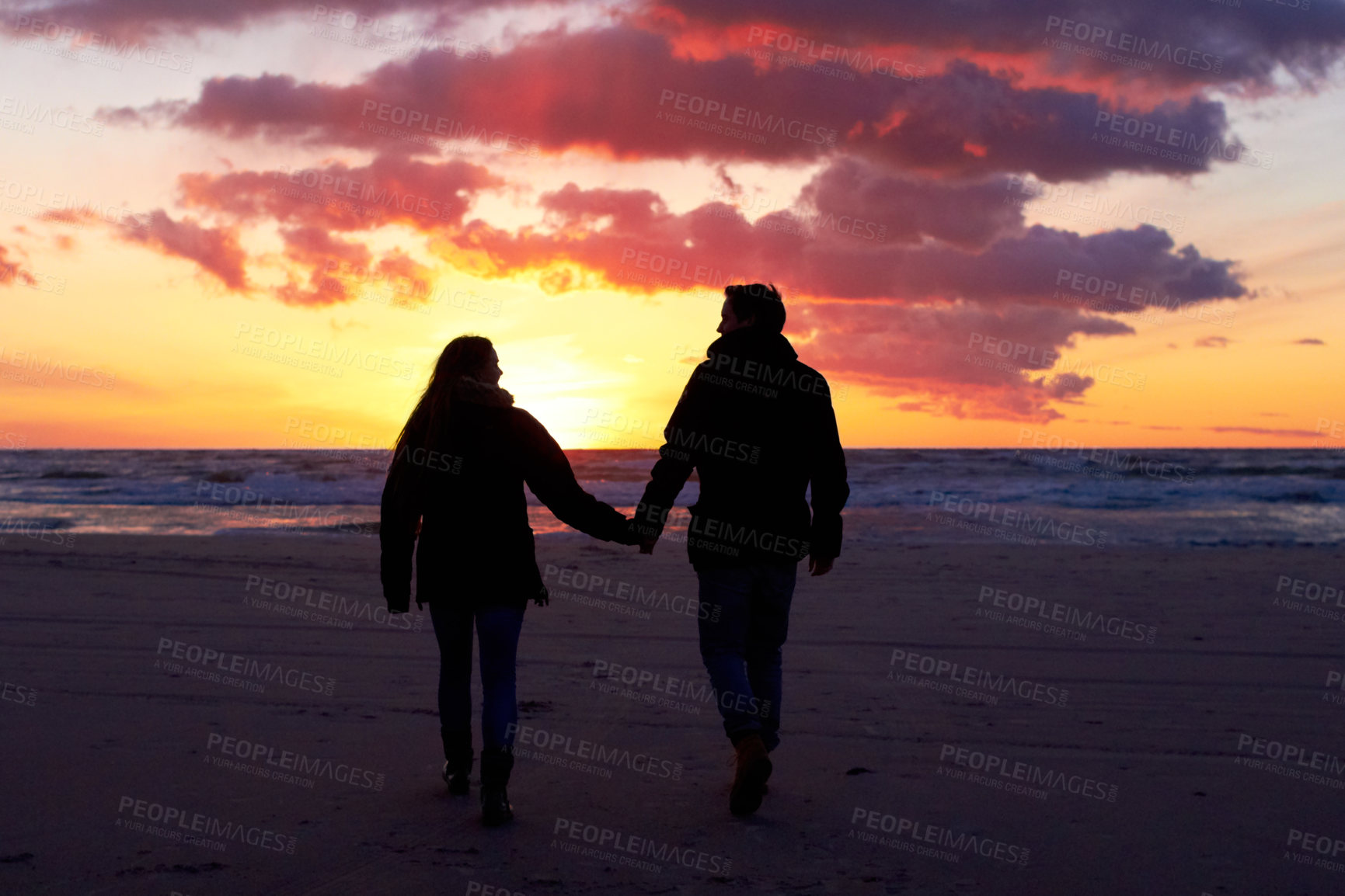 Buy stock photo Beach, silhouette and couple holding hands at sunset while walking, bonding and enjoying freedom. Love, shadow and man with woman at the ocean for travel, romance and sunrise walk on Hawaii vacation