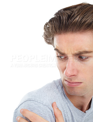 Buy stock photo Shoulder pain, injury and a man looking unhappy in studio isolated on a white background for recovery. Medical, anatomy and accident with a handsome young male person holding his joint in discomfort