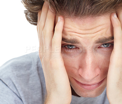 Buy stock photo Sad young man sitting with his head in his hands