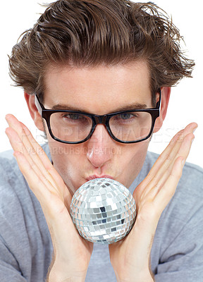 Buy stock photo Disco ball, kiss and portrait of a man with celebration, party and clubbing decoration in a studio. Isolated, white background and young male person with model face kissing a small partying deco