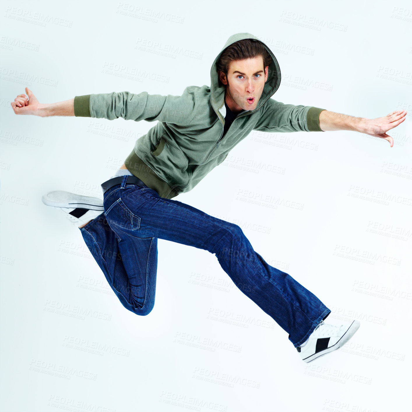 Buy stock photo Portrait of a young man posing while jumping in the air