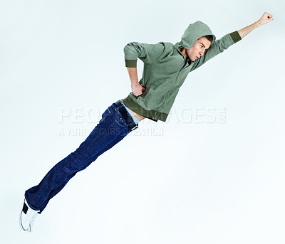 Buy stock photo Man in flying, superhero pose with fashion and stylish streetwear casual clothes isolated on white background. Energy, carefree with young male model is soaring and posing in jeans and hoodie