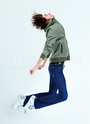 Buy stock photo A young man jumping while looking upwards
