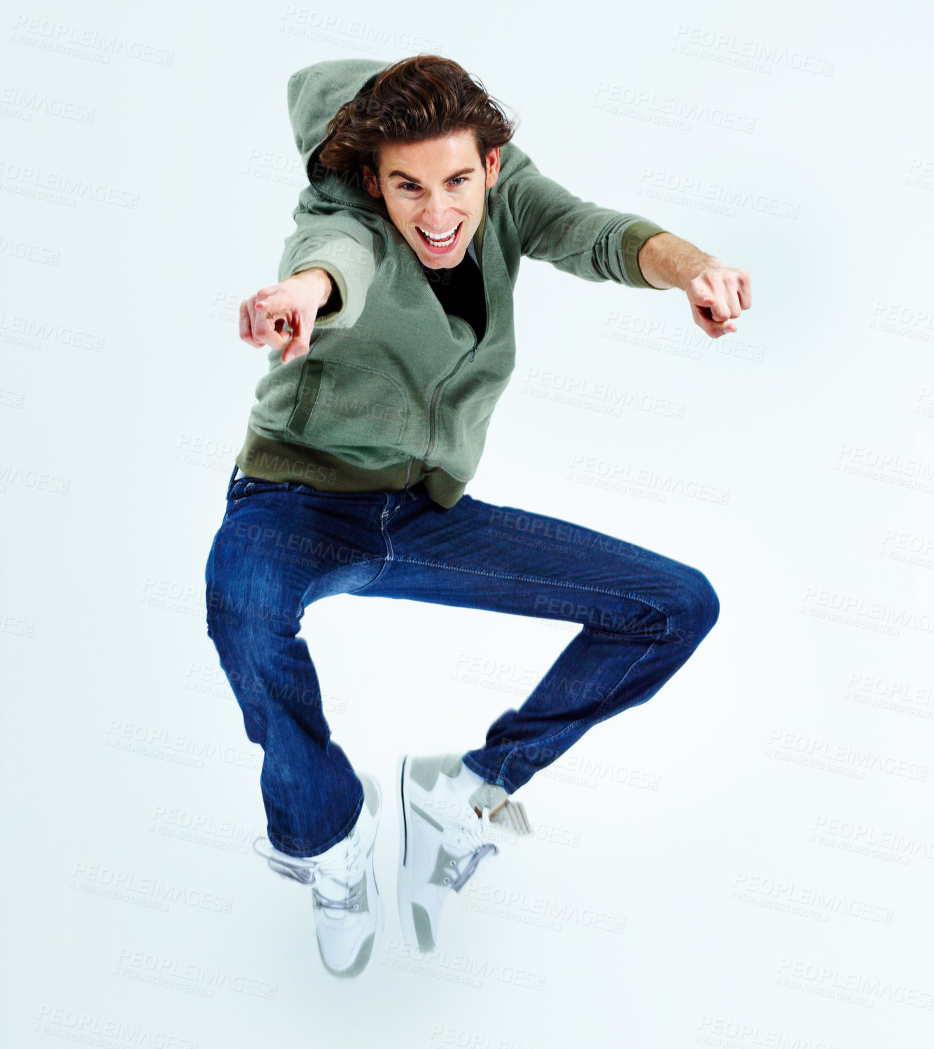 Buy stock photo Portrait of a young man jumping up in the air while pointing at you