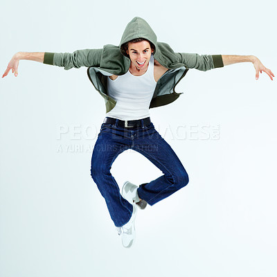 Buy stock photo Portrait of a young man jumping up and posing while in the air