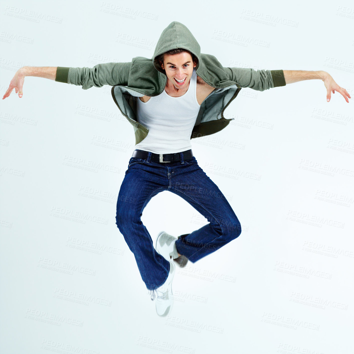 Buy stock photo Portrait of a young man jumping up and posing while in the air