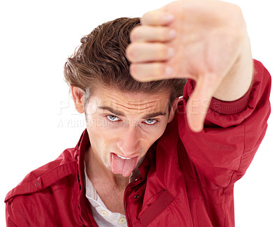 Buy stock photo Man in portrait with tongue out, thumbs down and hand gesture for bad opinion isolated on white background. Problem, disagreement and wrong young male person with rejection, fail and negative mindset