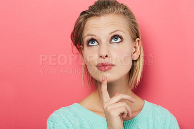 Buy stock photo A beautiful young woman thinking to herself while isolated on pink