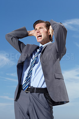 Buy stock photo Stress, blue sky and a business man screaming outdoor in frustration from tax, debt or financial crisis. Burnout, bankrupt and economy with an unemployed young person shouting in a corporate suit