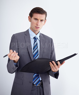 Buy stock photo Confused, portrait and man writing on paper documents in studio for compliance, complaint or discipline on white background. Face, hr and businessman with file for accountability or warning workplace
