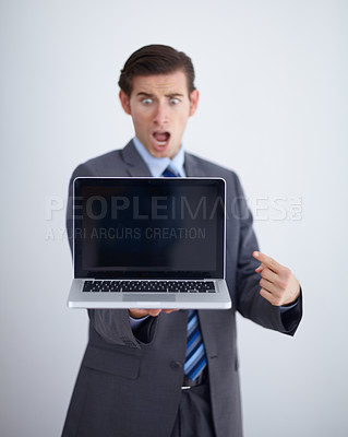 Buy stock photo Laptop screen, mockup and shocked with business man in studio for website, email and pointing. Wow, surprised and technology with employee in white background for corporate, internet and networking