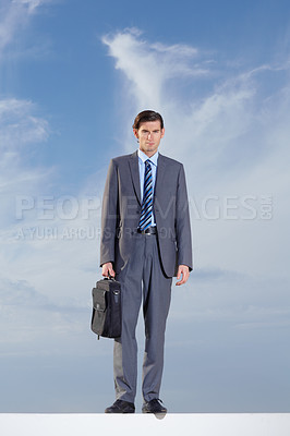 Buy stock photo Portrait, briefcase and a business man on a blue sky background for International travel or a journey. Corporate, work and a confident young professional employee outdoor during summer for a trip