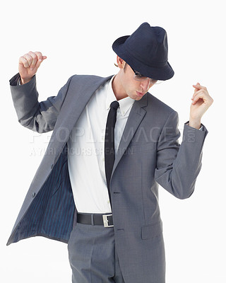 Buy stock photo A young man in a suit and hat dancing against a white background