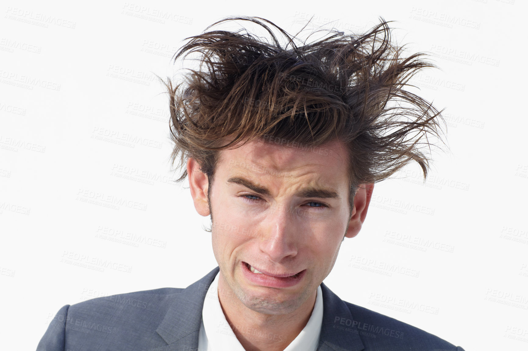 Buy stock photo A young businessman with messy hair whimpering while isolated on white