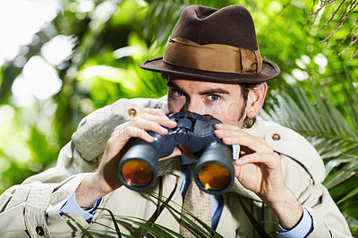 Buy stock photo Detective man, search and portrait in jungle with vintage gear for investigation and solution. Outdoor, private investigator and spy with binoculars for surveillance and retro reporter character