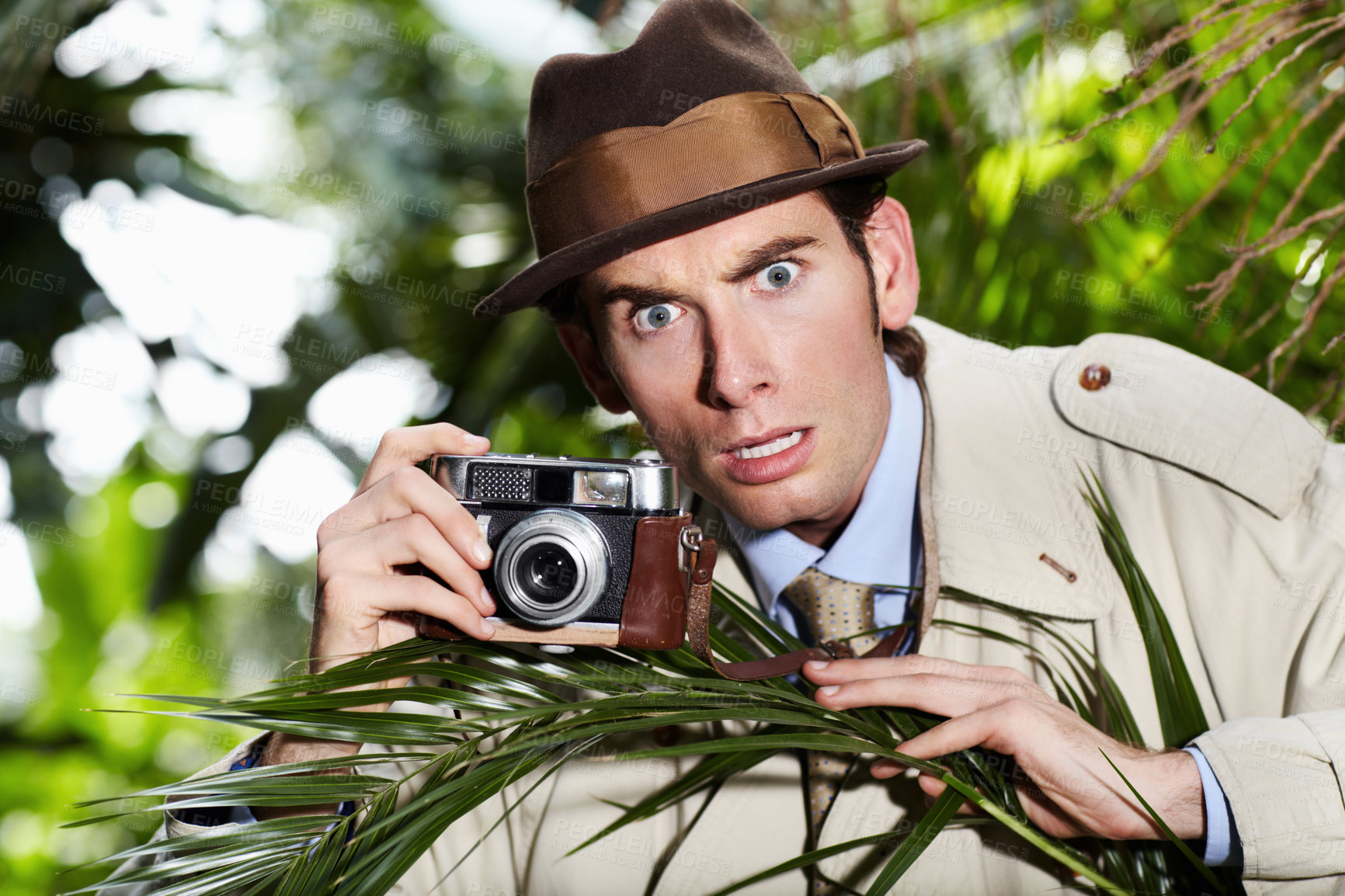 Buy stock photo Retro spy man, camera and jungle for investigation, inspection or journalist with shock at job. Private investigator, secret photographer and retro paparazzi in trees, bush or leaves for surveillance