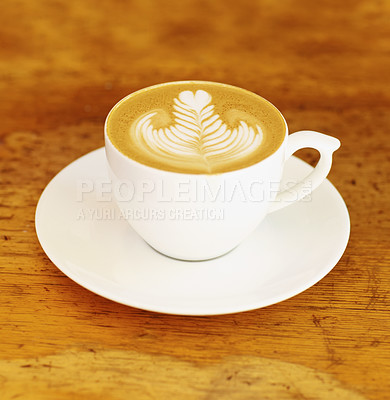 Buy stock photo Coffee, cafe and latte art in a cup on wooden table background in restaurant to drink espresso with foam. Retro, diner and mug with saucer in kitchen with vintage design during morning breakfast. 

