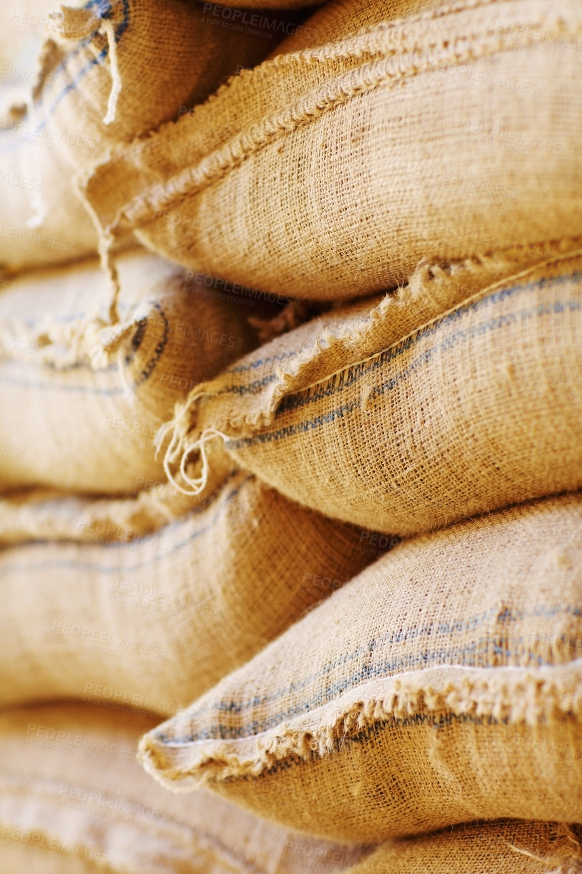 Buy stock photo Shot of burlap sacks filled with beans waiting for export