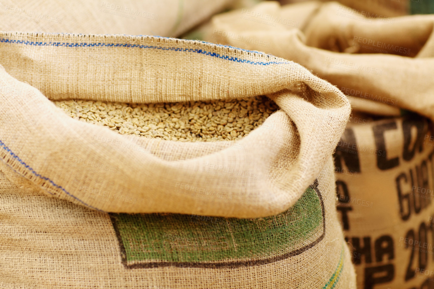 Buy stock photo Shot of burlap sacks fill with unprocessed coffee beans