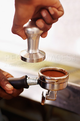 Buy stock photo Coffee, ground and barista hands press espresso with tamper, portafilter and fresh caffeine at cafe, hotel or restaurant. Brewing, beverage or cappuccino machine equipment for professional drink 