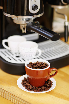 Buy stock photo Coffee beans, cups and machine on table in cafe for cappuccino, latte or hot drink. Restaurant, electrical appliance and caffeine mugs for making or brewing espresso in retail shop or small business.