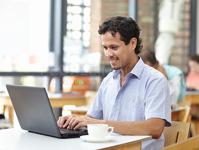 Buy stock photo Student man, laptop and cafe with smile, typing and research on internet for studying. Young guy, computer and coffee shop with happiness, reading and social media for news, search or video on web