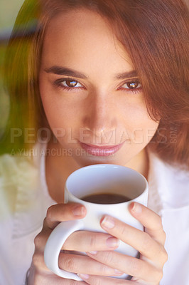 Buy stock photo Shot of an attractive woman holding her morning coffee