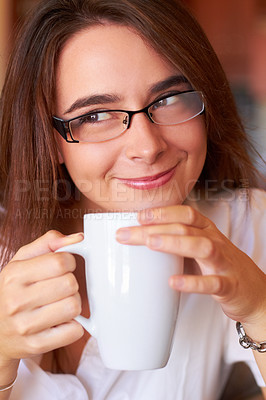 Buy stock photo A young woman drinking her coffee with a thoughtful look