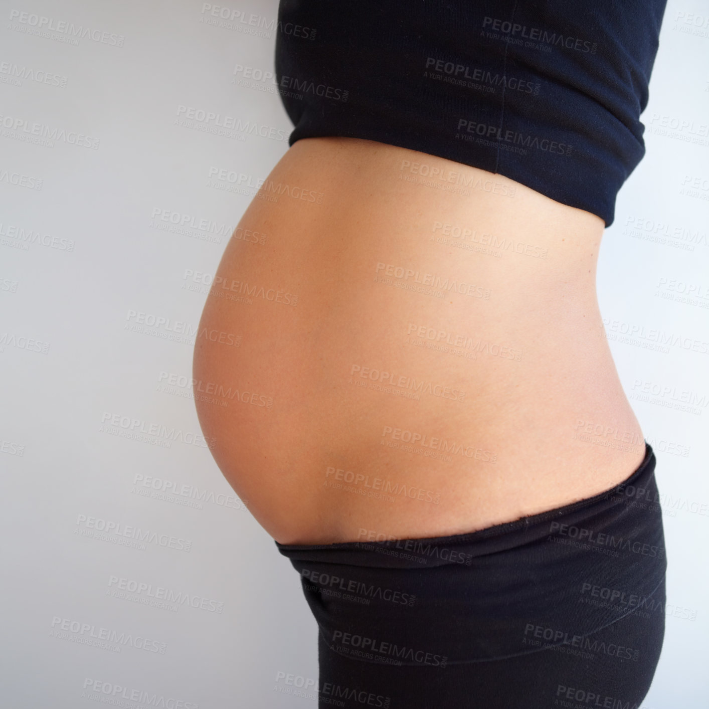 Buy stock photo Cropped shot of a side angle view of pregnant woman&#039;s stomach