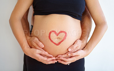 Buy stock photo Closeup, pregnant and woman with heart, stomach and bonding with nurture, health and wellness. Zoom, couple and hands with love symbol, support and belly with childcare, pregnancy and wellness