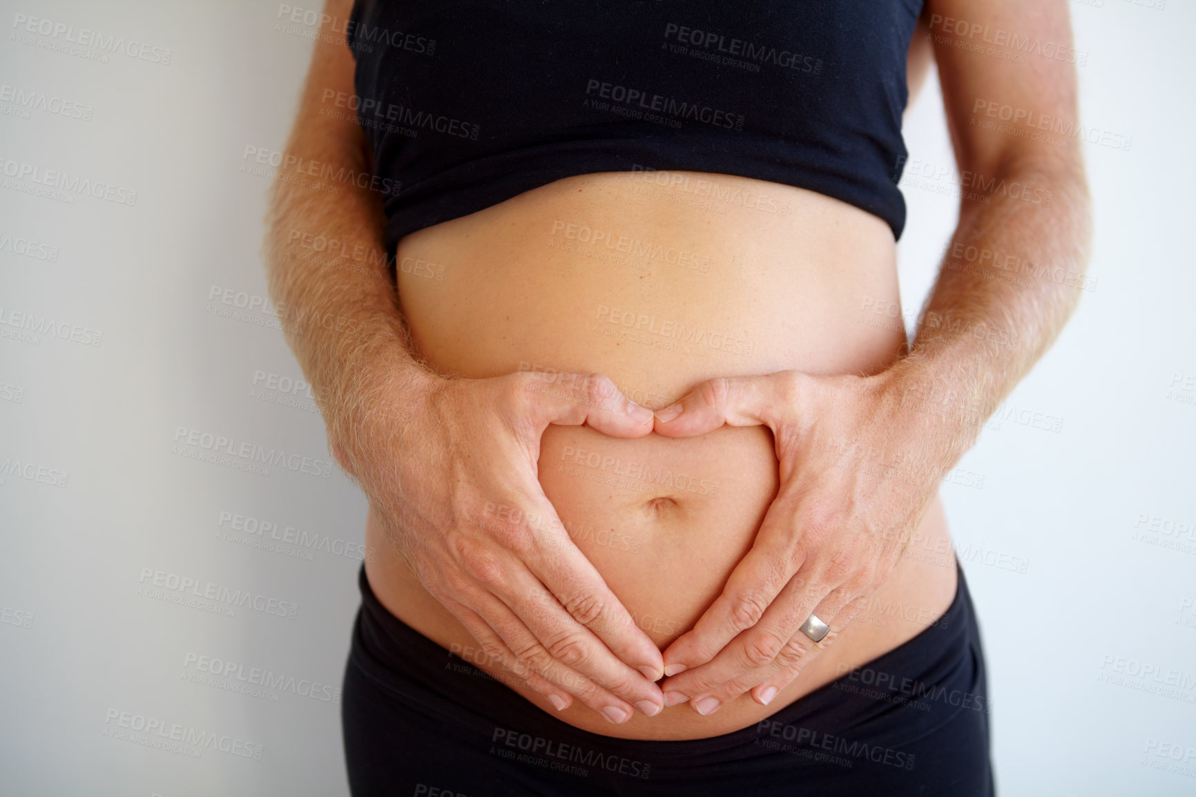 Buy stock photo Closeup, pregnant and woman with heart hands, stomach and health with childbirth, support or wellness. Zoom, pregnancy or female person touching belly, tummy or symbol for love with maternity or care