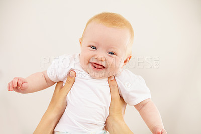 Buy stock photo An adorable baby girl being lifted into the air by her mother