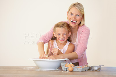Buy stock photo Portrait of a mother and daughter having fun while baking together