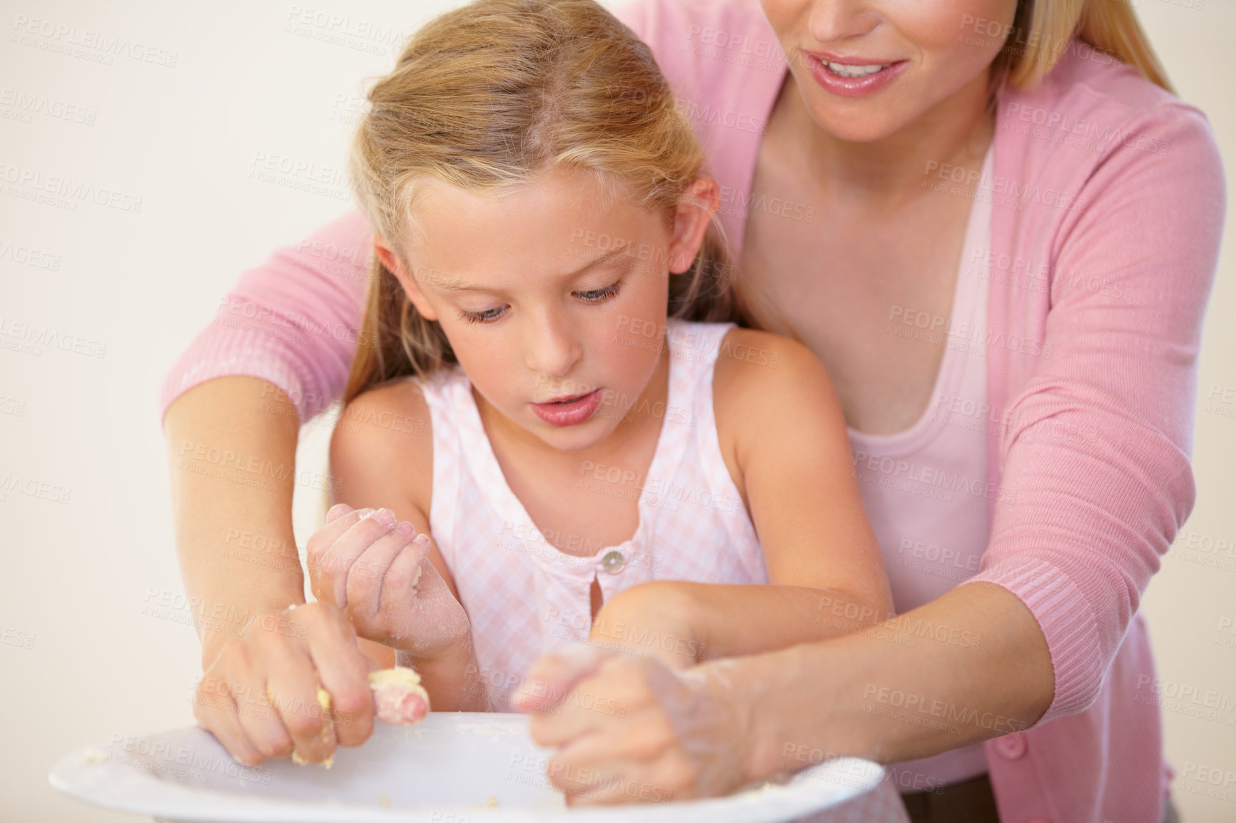 Buy stock photo Home, kitchen and baking mom, child or family parent helping, support or teaching girl recipe cooking process. Love, bowl or mama assisting young kid learning cooking, essential skills or ingredients