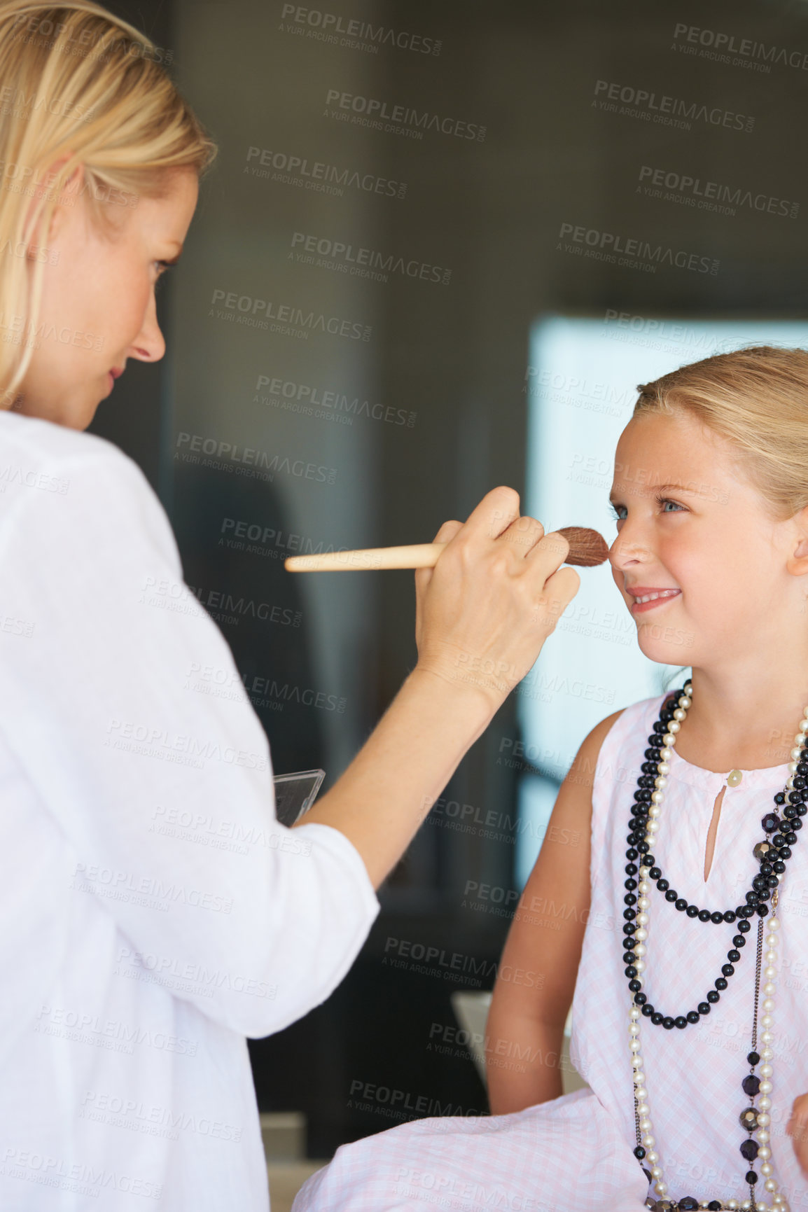 Buy stock photo Mother, child and smile for foundation, makeup and support in bathroom, brush and fun at home. Mom, daughter and learning or beauty, cosmetics and skincare or bonding, love and teaching or grooming