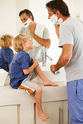 Buy stock photo Shaving, father and child with cream on face, smile and bonding in home with morning routine. Teaching, learning and dad with happy son in bathroom for family, clean fun and grooming together.