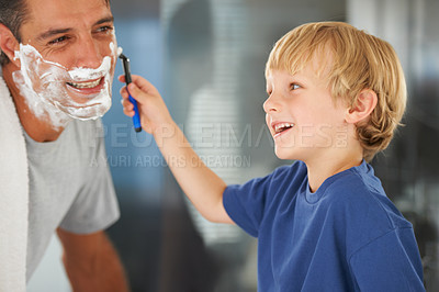 Buy stock photo Help with shaving, dad and child with razor, cream on face and bonding in home with morning routine. Teaching, learning and father with happy son in bathroom for love, clean fun or grooming together