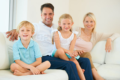 Buy stock photo Family, portrait and happy on sofa with relax, peace and love for bonding and relationship in living room. Parents, kids and face with smile on couch of lounge with care, break and enjoyment in home