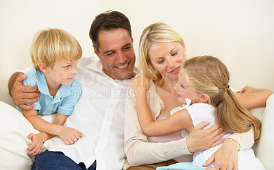 Buy stock photo Family, hug and happy on sofa with love, peace and care for bonding and relationship in living room. Parents, children and face with smile on couch of lounge with relax, break and enjoyment in home
