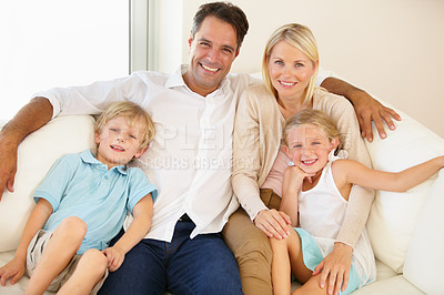 Buy stock photo Family, portrait and smile on sofa with relax, peace and love for bonding and relationship in living room. Parents, kids and face with happy on couch of lounge with care, break and enjoyment in home
