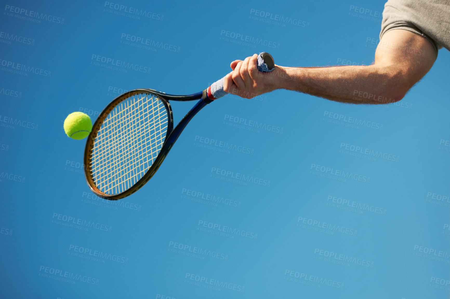 Buy stock photo Shot of a arm hitting a tennis ball with a racket