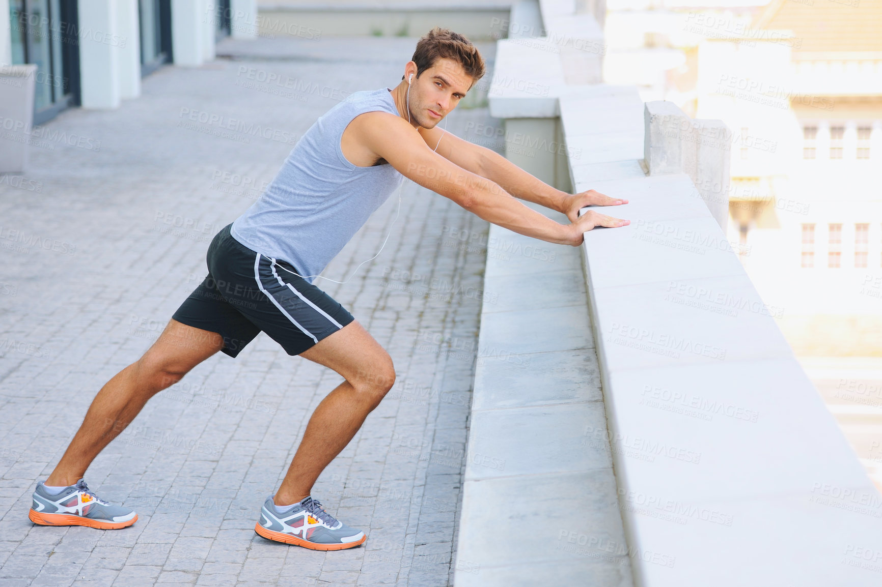 Buy stock photo Man, portrait and stretching body on balcony in city for fitness, workout or outdoor exercise. Active male person in warm up, stretch or preparation for training or run in health and wellness outside