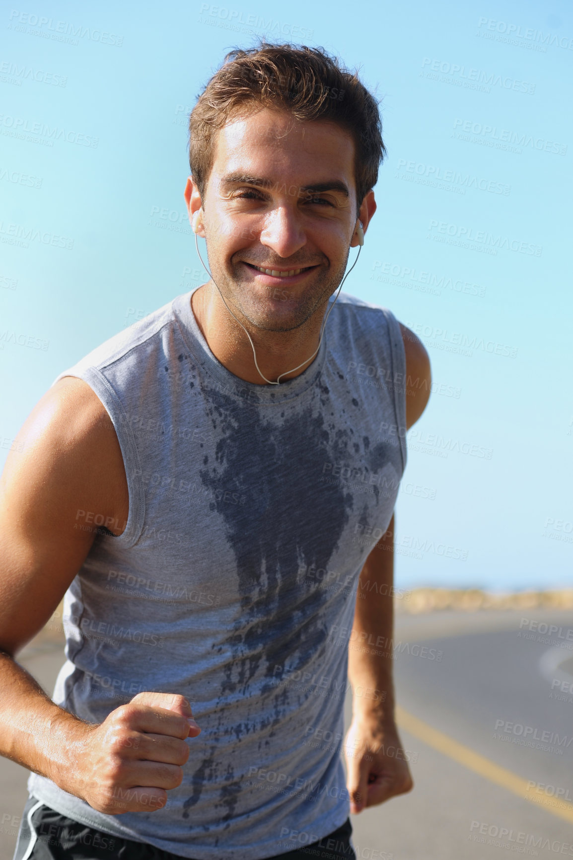Buy stock photo Happy man, portrait and running on road in fitness for exercise, cardio or outdoor training. Active male person smile with earphones for run on street or sidewalk in sweat for health and wellness