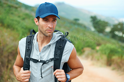 Buy stock photo Young hiker wearing a backpack looking sideways