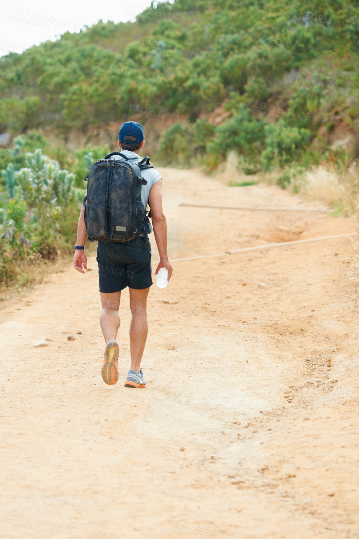 Buy stock photo Fitness, back or man hiking in nature with water, backpack or energy drink for workout, training or exercise freedom. Hiker, Brazil or walking on mountains path for health, wellness or summer sports