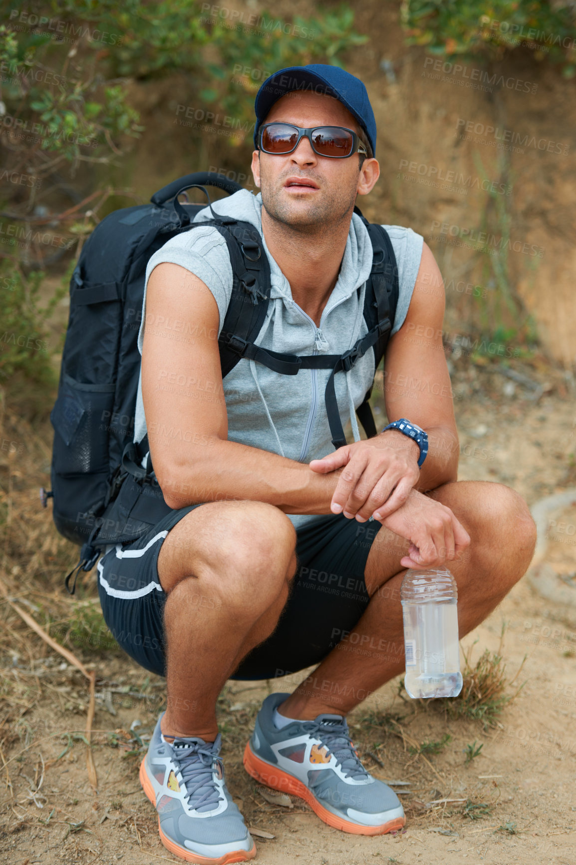 Buy stock photo Fitness, man and thinking of nature hiking with water, backpack and energy drink for workout, training and exercise. Hiker, person and planning mountains trail for health, wellness and summer sports
