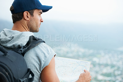 Buy stock photo Young hiker holding a map and looking at the scenic view