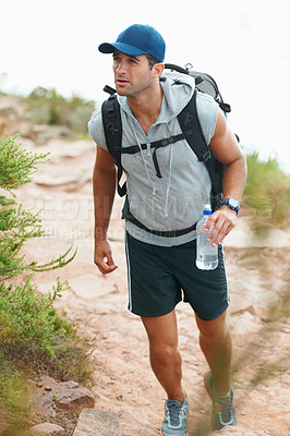 Buy stock photo Happy young hiker walking with a bottle of water in his hand