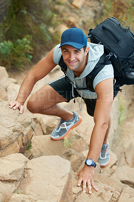 Buy stock photo Young hiker climbing up a cliff - portrait